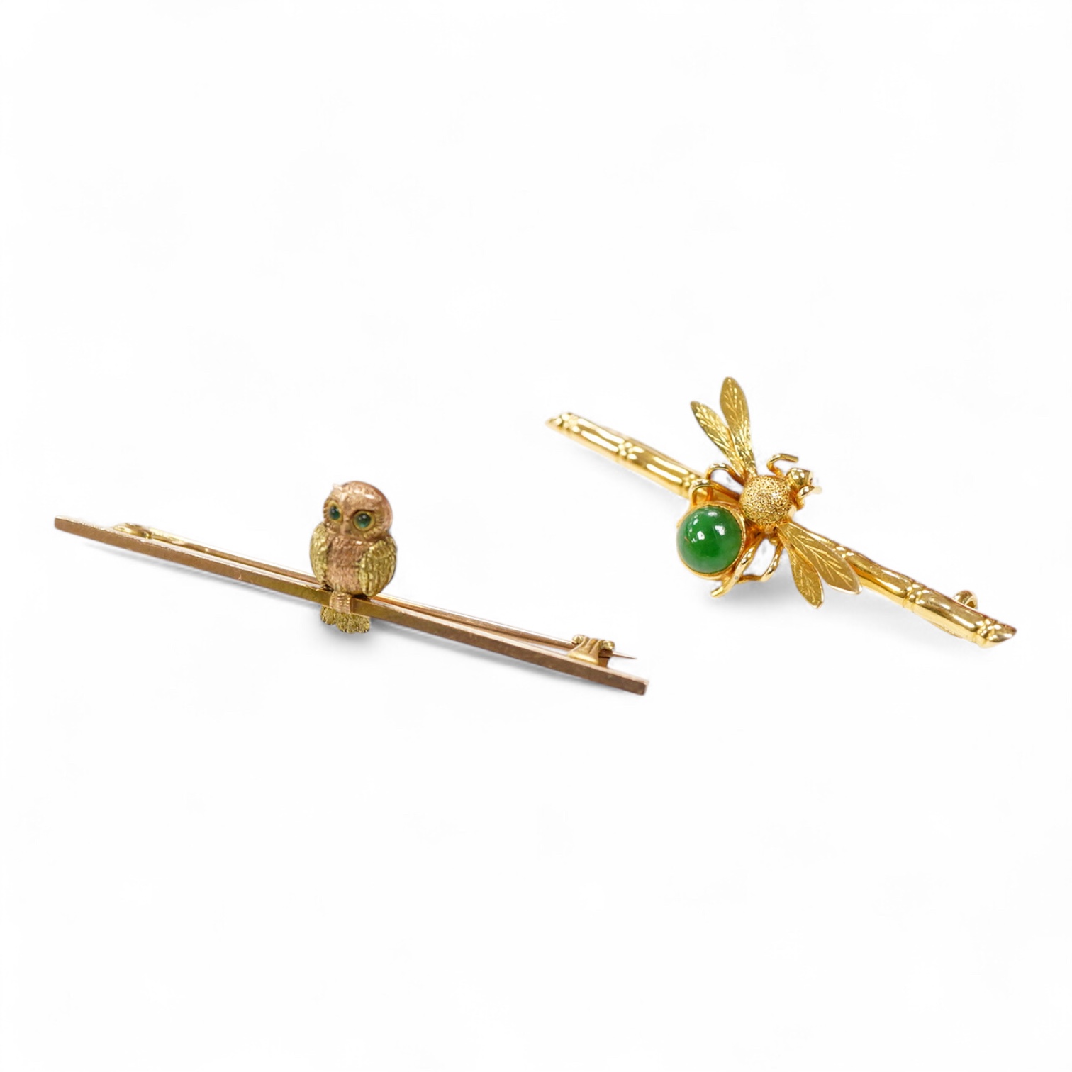 An Edwardian two colour 9ct owl bar brooch, with green cabochon eyes, 48mm, gross 2.5 grams, together with a yellow metal (stamped 20) and single stone cabochon jade set bug bar brooch, gross weight 3.7 grams.
